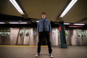 Independent music artist, rapper and producer Boy Pierce in front of a New York City subway.