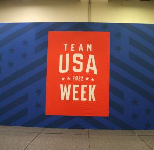 The Team USA logo on a step and repeat banner.