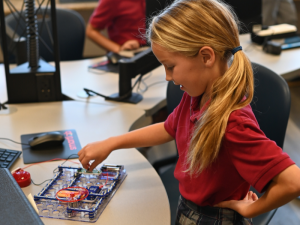 Student from St. Joseph looking working with a SmartLab kit