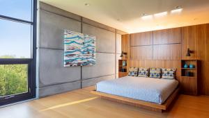 Retire to the secluded sleeping quarters, including the master suite with massive two-story curtainwall windows.