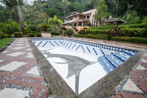 Stroll along the sandy beach, or lounge by the expansive pool.
