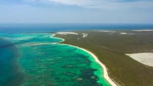 A staggering 6,435± feet of pristine white sand beach frontage greets you upon arrival at the northern shore.