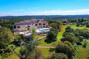 Impeccably landscaped gardens provide privacy for the front of the home, while the rear opens to the third hole of the Fazio Foothills Golf Course.