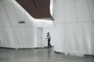 Janitor cleaning large building lobby