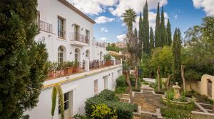 A manicured courtyard, complete with water fountains and plentiful fruit trees, brings you to the ornate antique double entrance doors.