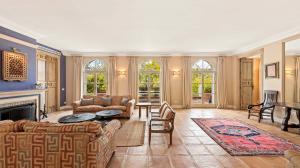 Beyond the doors is a spectacular double-height grand foyer with a sweeping staircase that leads to the upper gallery and the bedroom suites beyond.