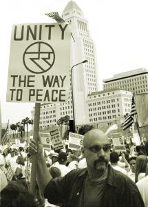 Angel Tenez is seen holding a sign with unity symbol