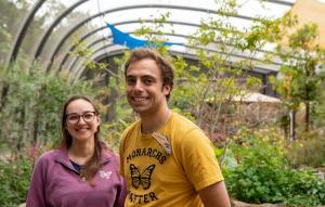 Man and woman in the butterfly pavilion with a blue morpho butterfly on the man's shirt