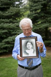 Holocaust survivor Joe Rubinstein holds a photo a photo of his mom that he had not seen since being taken from the ghetto in Radom, Poland, during WWII. Joe is still searching for photos of a younger brother and sister. ( Photo by Crystal Merrill 2019)