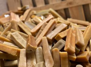 A huge pile of 100% natural Yak Cheese Dog Chews from Mighty Paw Naturals