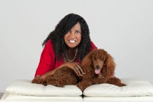 A photo of Denise Meridith, President of Read to Kids US, and her poodle Arry