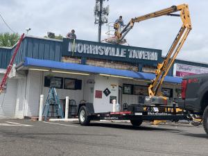 Slicks Graphics installing the new Morrisville Tavern Sign