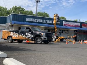 Completing the Morrisville Tavern sign installation.