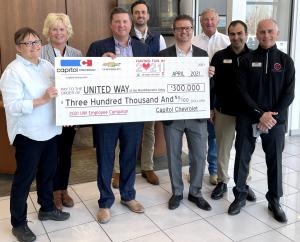 United Way of the Mid-Willamette Valley accepts a check from Capitol Auto Group