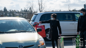 Volunteers from Iglesia Ni Cristo giving care package to frontliner at Aid To Humanity event in Victoria, Canada on March 28