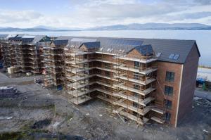 Buying off-plan can seem both tempting and scary House development construction site in progress aerial view