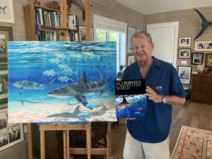 Dr. Guy Harvey holds a copy of his latest book - Guy Harvey's Underwater World