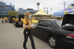 Volunteer Ministers placed food boxes in trunks of the cars that drove through the Church of Scientology parking lot.