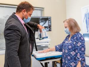 Dr. Gregory Kolovich, inventor of Micro C, takes x-rays of a patient at the point of care.