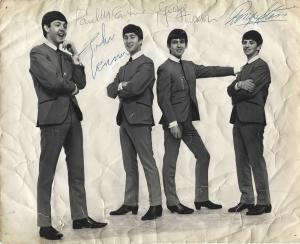 Vintage 8 inch by 10 inch photograph, featuring the Fab Four in their iconic, collarless suits, signed by all four Beatles