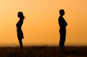 Couple with arms crossed and backs to each other
