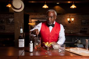 Louisville Tourism, the marketing agency that promotes the city as a travel destination, unveils new programming celebrating the impact of the African American contribution to Louisville’s history, heritage and culture An actor as Tom Bullock guides visitors through Bourbon tastings in the Evan Williams Bourbon Experience speakeasy