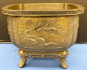 Square, Japanese bronze planter decorated in relief. Estimate: $300-$500.