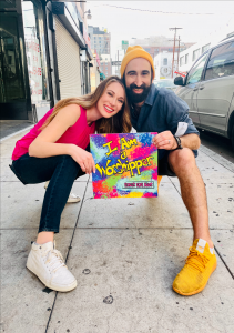 Anthony & Tiffany Salerno hold the album cover for "I Am a Worshipper" outside FD Studio in Downtown Los Angeles after shooting the music video for their single, "Stars and Dots," which is the first song on the album.