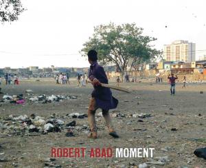 Two boys in Mumbai playing cricket in dirty field