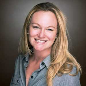 A woman with blonde hair in a blue blouse