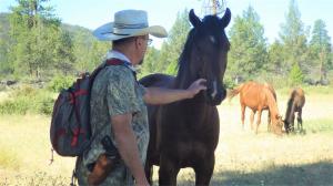 “I was outside my cabin in the serenity of the mountains visiting with a few of the local wild horses when a text popped up on my phone saying; ‘Hello William! This is Ashley Avis…’ A mighty mountain stallion, greets Naturalist William E. SImpson II
