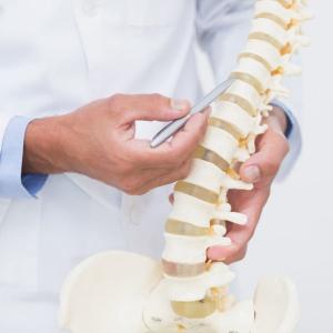 doctor pointing to spine for MIS implant
