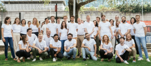 A group photo of CitizenLab's team standing together outdoors