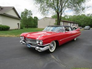 Completely restored, iconic 1959 Cadillac convertible, series 62 model, red in color with a white convertible top, a 325 hp 390 c.i. V8 engine.