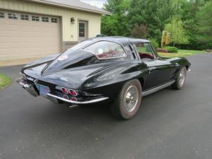 Super-rare, frame-off restoration 1963 Chevrolet split-window Corvette, tuxedo black with red leather interior, powered by a fuel-injected 327 V8 engine.