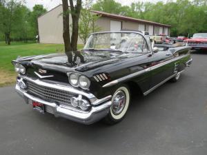 Beautiful 1958 Chevrolet Impala convertible, the first year for the dual headlights and bigger motor, black with a white convertible top, with a 348 hp V8 engine.