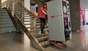 Transporting a vending machine up stairs with the stair climbing robot Domino Automatic