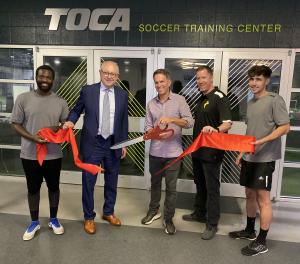 Franklin Mayor Ken Moore joins a few members of TOCA team to celebrate the center's expansion of programs
