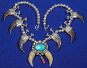 Hollow silver bead necklace with six bear claws capped with silver adornments, plus a central turquoise cabochon (estimate: $2,000-$4,000).