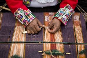 Unique gifts: The hands of Victoria Quispe Mamani, weaving alpaca apparel for individual NOVICA.com customers.