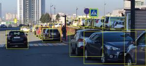 Image presents ADAS camera work which is set on the windshield of the car and detects road objects and send warnings to driver in case of unsafe situation