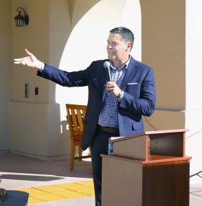 Managing Partner at The Orchards Healthcare Center Troy Bourne speaks to the attendees at the private event celebrating the first anniversary and grand opening ribbon cutting.