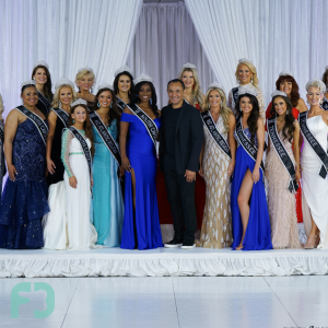 Beauty queens standing on stage with Gil Villavecer at the Cosmos Pageant