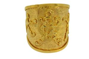 Wide cuff bracelet by the renowned designers Jean Mahie, executed in their usual heavy, solid 22kt gold abstract figures design, signed and hallmarked (est. $10,000-$20,000).