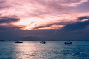 A picture of a beautiful sunset off the coast of Cozumel, Mexico, with fantastic beaches to visit