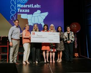 San Antonio Express-News Publisher Mark Medici, VP Lisa Gillespie, HearstLab VP Lisa Burton O'Toole, and HearstLab Chairwoman Eve Burton stand with Junum Founder & CEO Molly Hegarty and Team as they accept their $100,000 check.