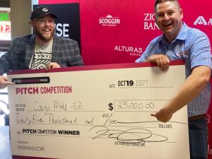 Boise Entrepreneur Week co-chair Nick Crabbs awards Adam Stock his grand prize for winning Boise Entrepreneur Week’s 2021 main pitch competition