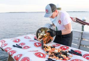 Pouring out a Signature Seafood Boil