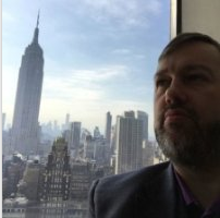 Karl Smith in Grace Building NYC with view of Empire State Building