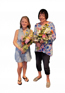 Two woman holding flowers at the Peoria Florist Bouquets & Bubbles flower design class Vistancia Peoria, AZ